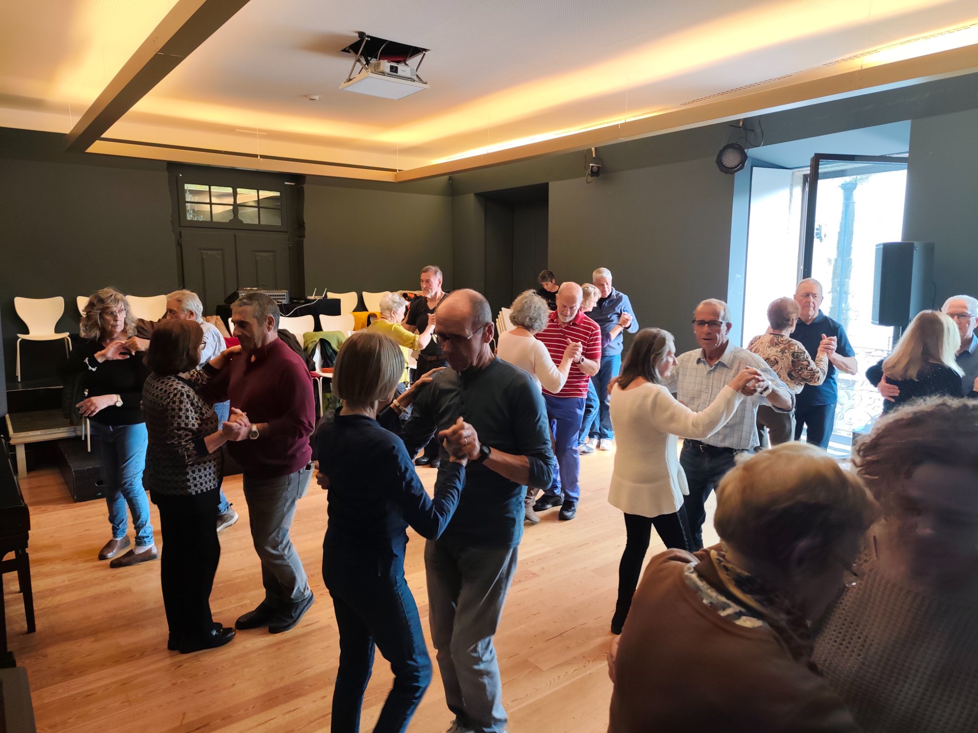 Participantes em aula de Dança 55+ a dançar a pares